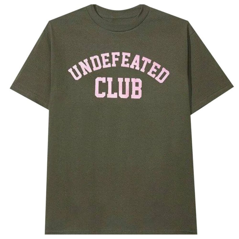 An olive green short-sleeve t-shirt with 'UNDEFEATED CLUB' printed in pink varsity-style lettering across the chest, shown against a plain white background.