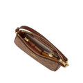 Brown leather handbag with gold zipper on a light gray background