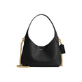 A black leather shoulder bag with a gold chain strap and a small gold Coach logo on the front, shown against a plain white background.