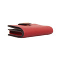 A red textured leather wallet shown from a side profile view on a plain white background.
