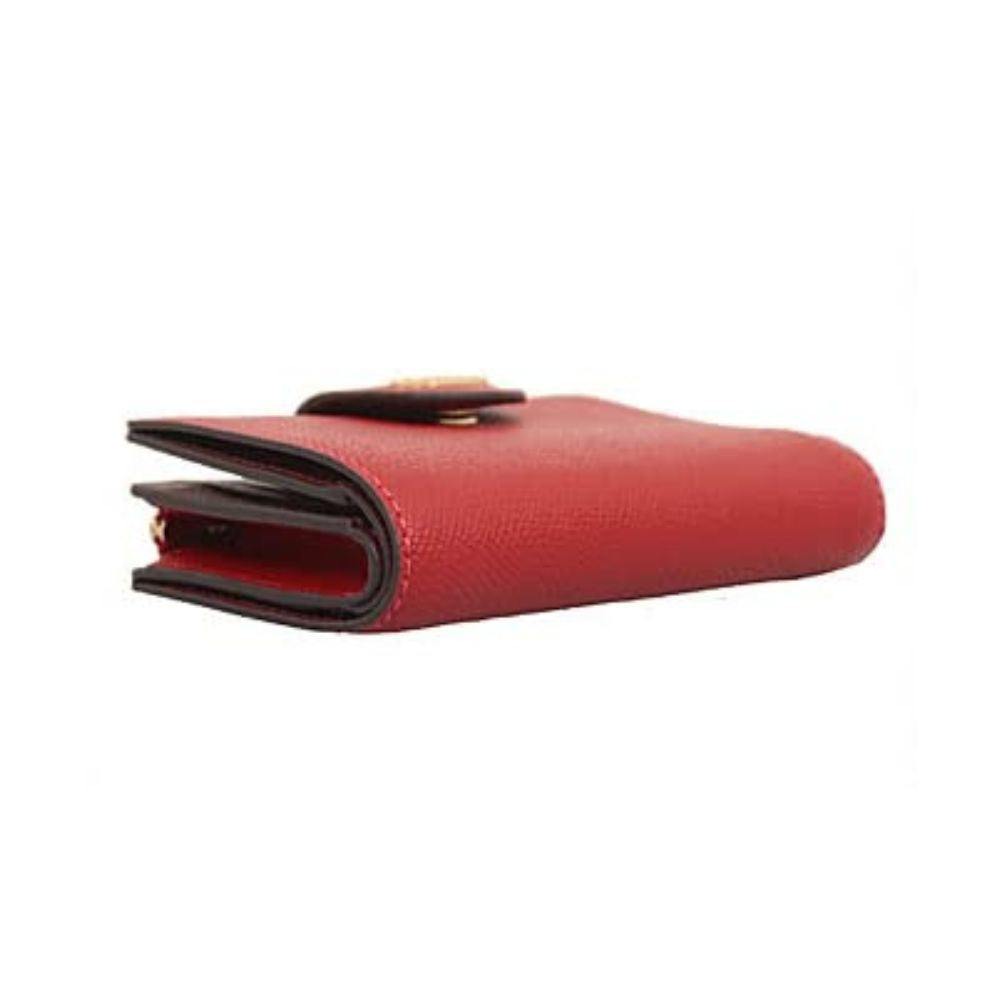 A red textured leather wallet shown from a side profile view on a plain white background.