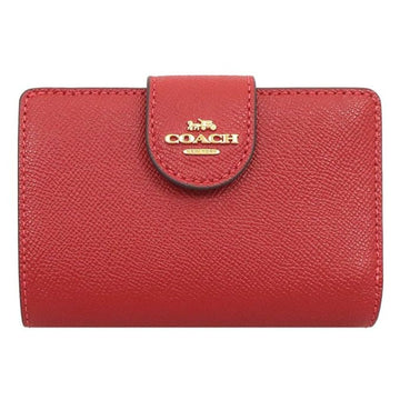 A red pebbled leather Coach wallet with a gold-tone logo on the front flap, shown against a plain white background.