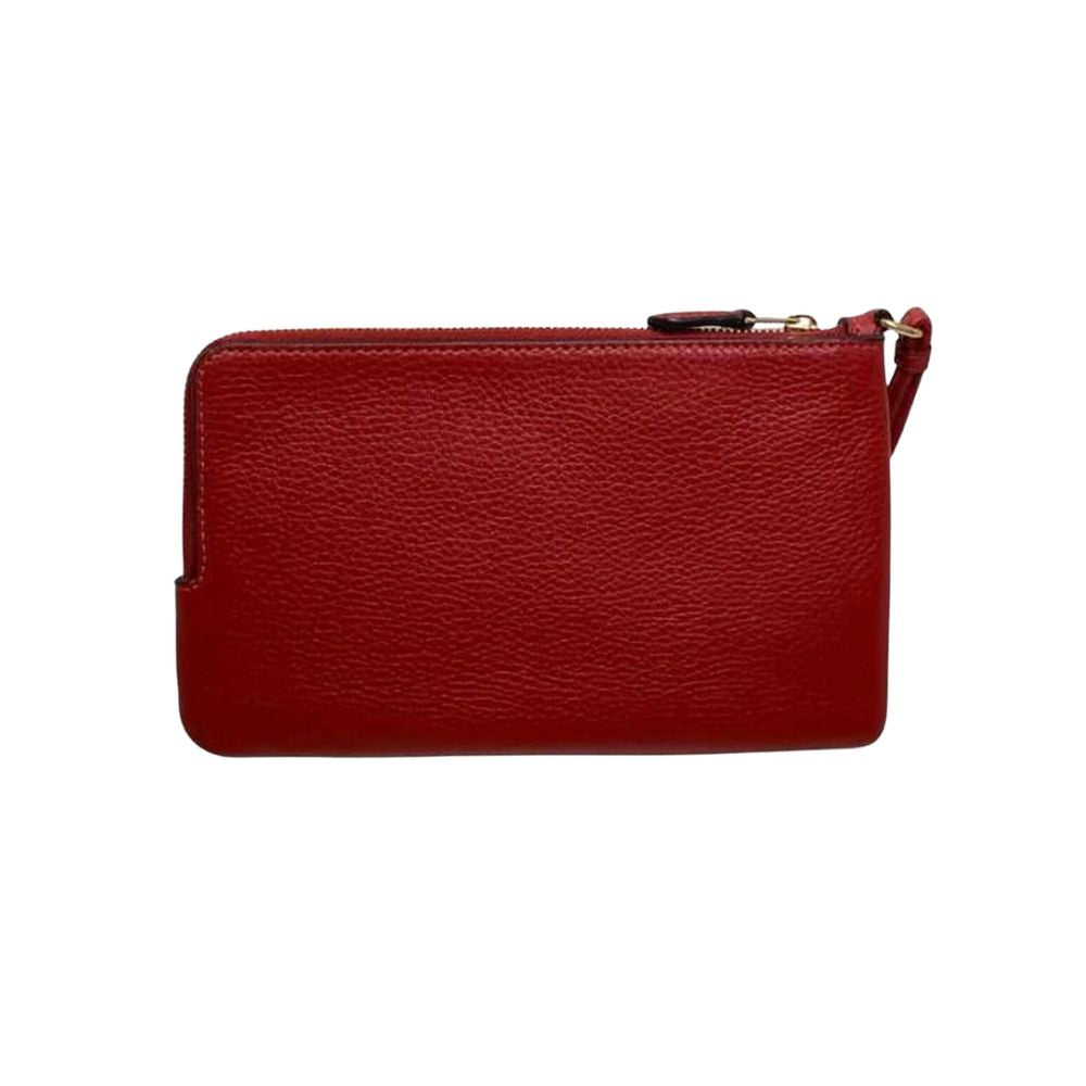 A red pebbled leather wristlet clutch with a top zipper and a small wrist strap, shown against a plain white background.