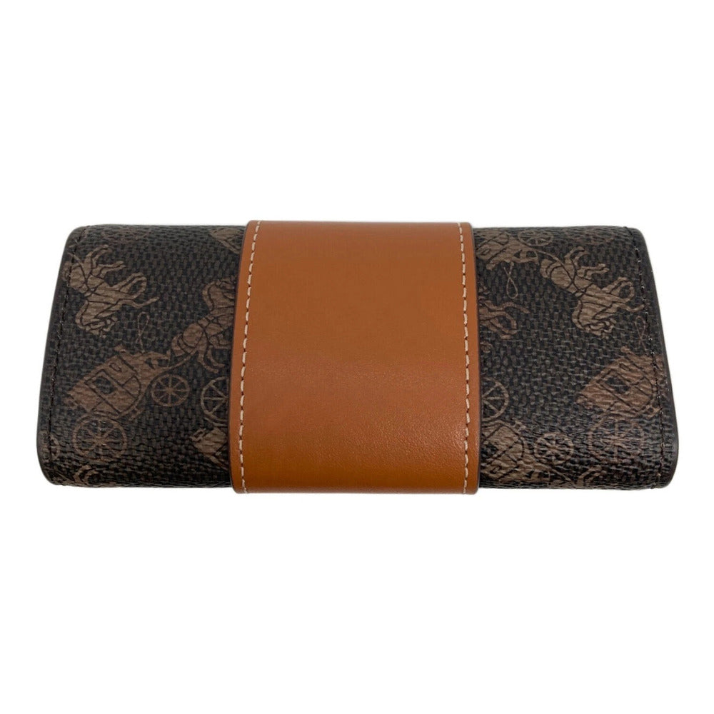 A folded wallet or clutch featuring a dark brown and black horse-drawn carriage monogram pattern with a prominent tan leather center band and white contrast stitching.