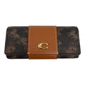 A Coach wallet in the brand's signature brown monogram canvas, featuring a tan leather center band with white contrast stitching and a gold-tone 'C' logo clasp.