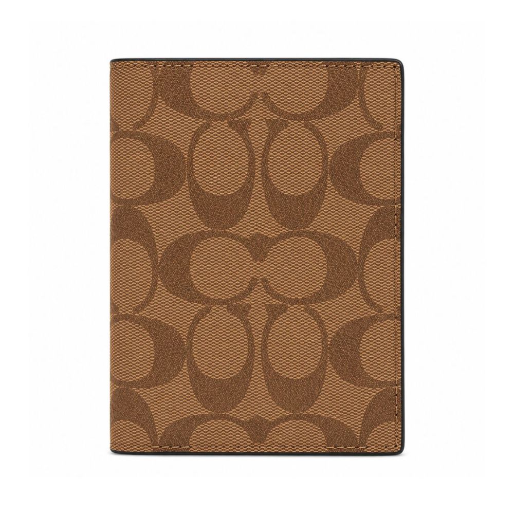 A brown and tan Coach signature pattern passport cover or notebook cover shown flat against a plain white background.