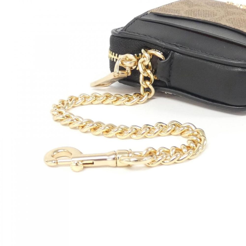 A close-up of a black leather or faux-leather pouch with a gold-tone chain strap and clasp, shown on a white background.