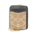 A Coach mini card holder wallet in signature canvas with black leather trim and a gold-tone chain strap, shown on a plain white background.
