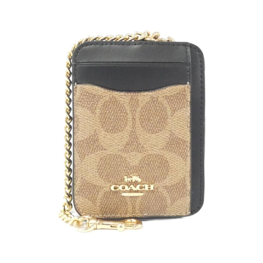 A Coach mini card holder wallet in signature canvas with black leather trim and a gold-tone chain strap, shown on a plain white background.