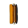 A top-down view of a black leather clutch bag with a gold-tone zipper and hardware, showing a vibrant mustard yellow interior lining, set against a plain white background.