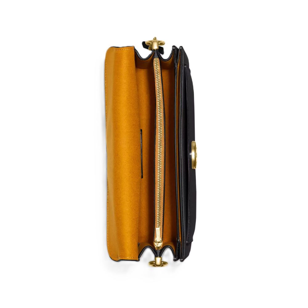 A top-down view of a black leather clutch bag with a gold-tone zipper and hardware, showing a vibrant mustard yellow interior lining, set against a plain white background.