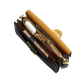 A black leather crossbody bag with gold-tone hardware, shown open to reveal its interior compartments, a tan suede-like lining, and gold zipper details, set against a plain white background.