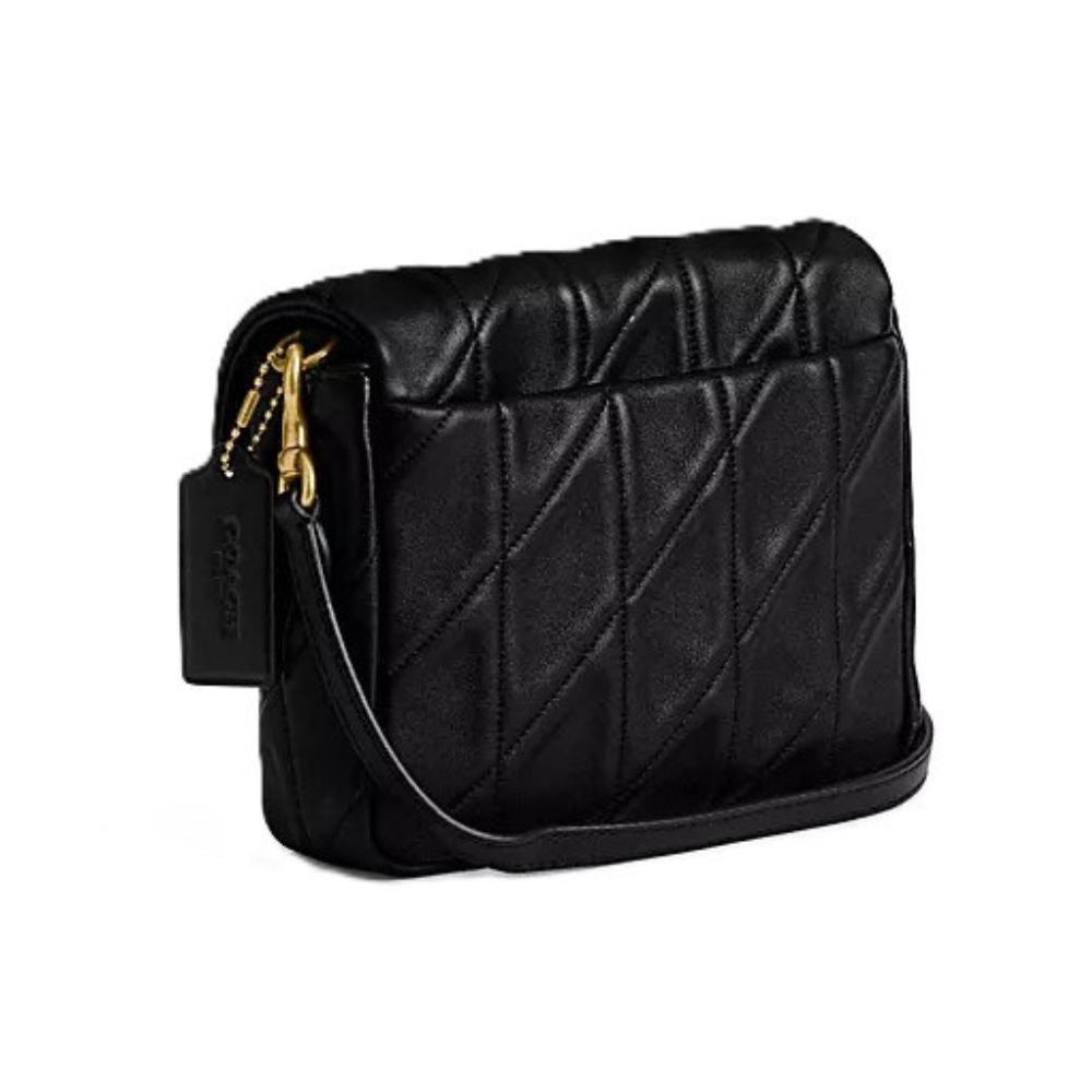 A black quilted leather shoulder bag with gold-tone hardware and a hanging black leather tag, shown on a plain white background.