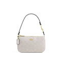 A Coach shoulder bag in light beige monogram canvas with a black leather strap and gold-tone hardware, shown against a plain white background.