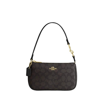 Black Coach handbag with gold accents on a light gray background
