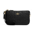 A black Coach crossbody bag with an embossed signature C pattern, gold-tone hardware, and a wristlet strap, shown against a plain white background.