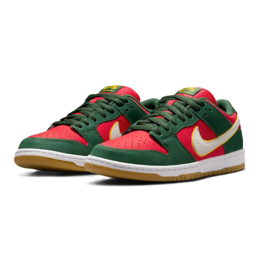 A Nike Dunk sneaker in a red and dark green colorway, featuring a white Swoosh outlined in gold, a red tongue, and a brown gum sole, shown against a plain white background.