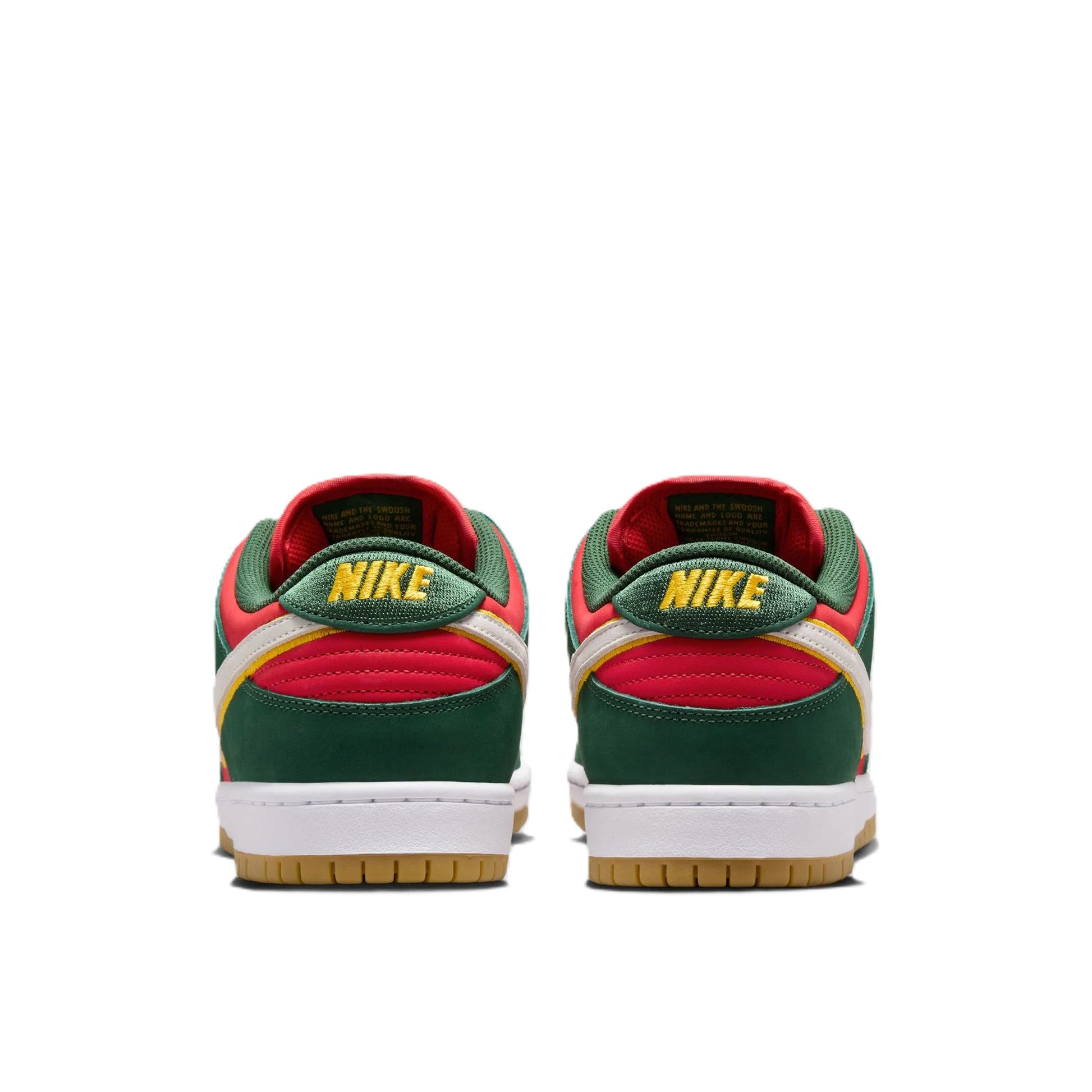 A pair of Nike Dunk Low sneakers shown from the back, featuring green, red, and yellow overlays with a white midsole and a gum outsole.