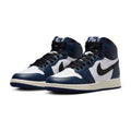 A pair of Nike Air Jordan 1 High sneakers in navy blue, white, and black, displayed against a clean white background.
