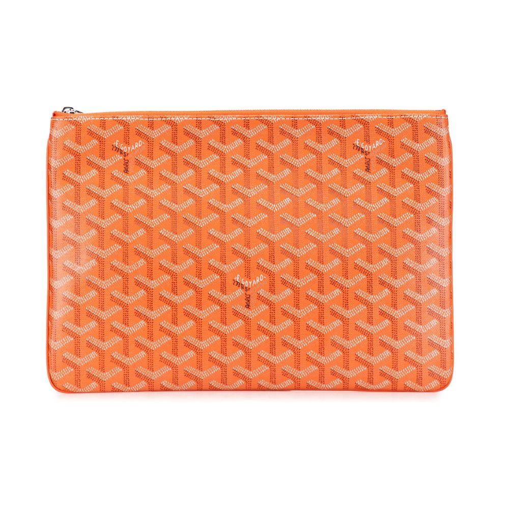 An orange Goyardine zip pouch featuring the brand's signature repeating chevron pattern in orange and white, shown against a plain white background.