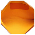 Close-up of the interior of a bag, showing a bright orange fabric lining with a matching orange leather patch on the back wall and silver-tone zipper edges.