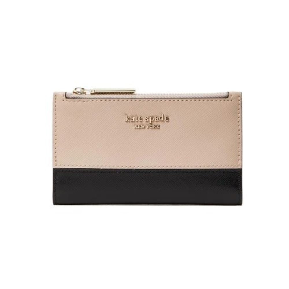A Kate Spade New York zip-around wallet in a two-tone color-blocked design, featuring a light beige textured leather top half and a black leather bottom half, with gold-tone hardware and logo lettering.