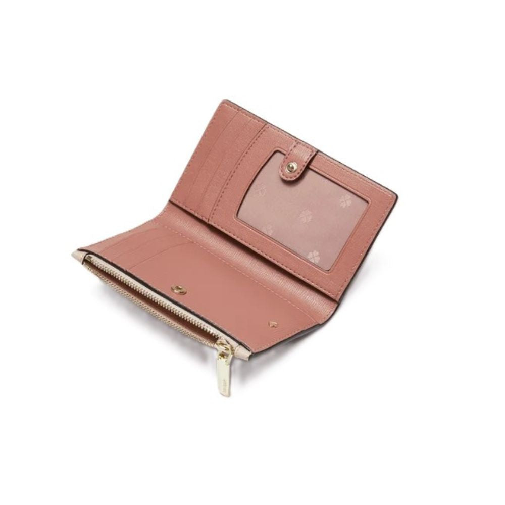 A small bi-fold wallet in dusty rose pink leather, shown open to reveal interior card slots, a clear ID window, and a gold-tone zipper compartment.