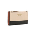 A Kate Spade zip-around wallet in a colorblock design with a beige top section, a black bottom section, and a brown side panel, shown on a plain white background.