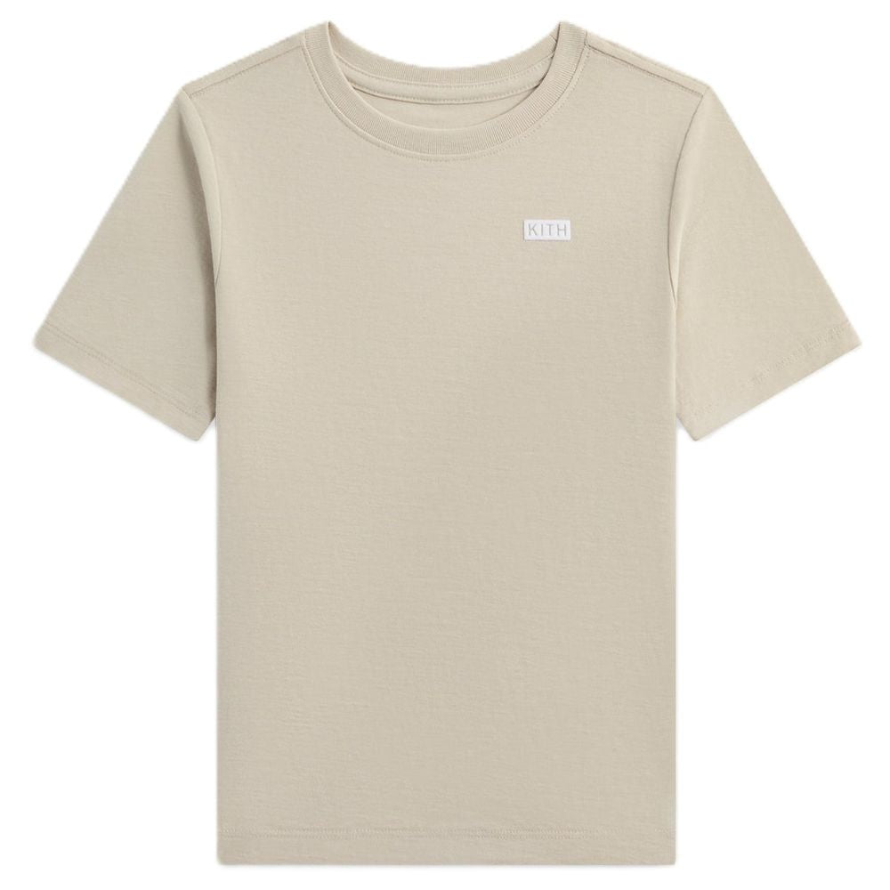 A short-sleeve crewneck t-shirt in a light beige color, featuring a small white rectangular KLEIN logo patch on the left chest, displayed against a solid white background.