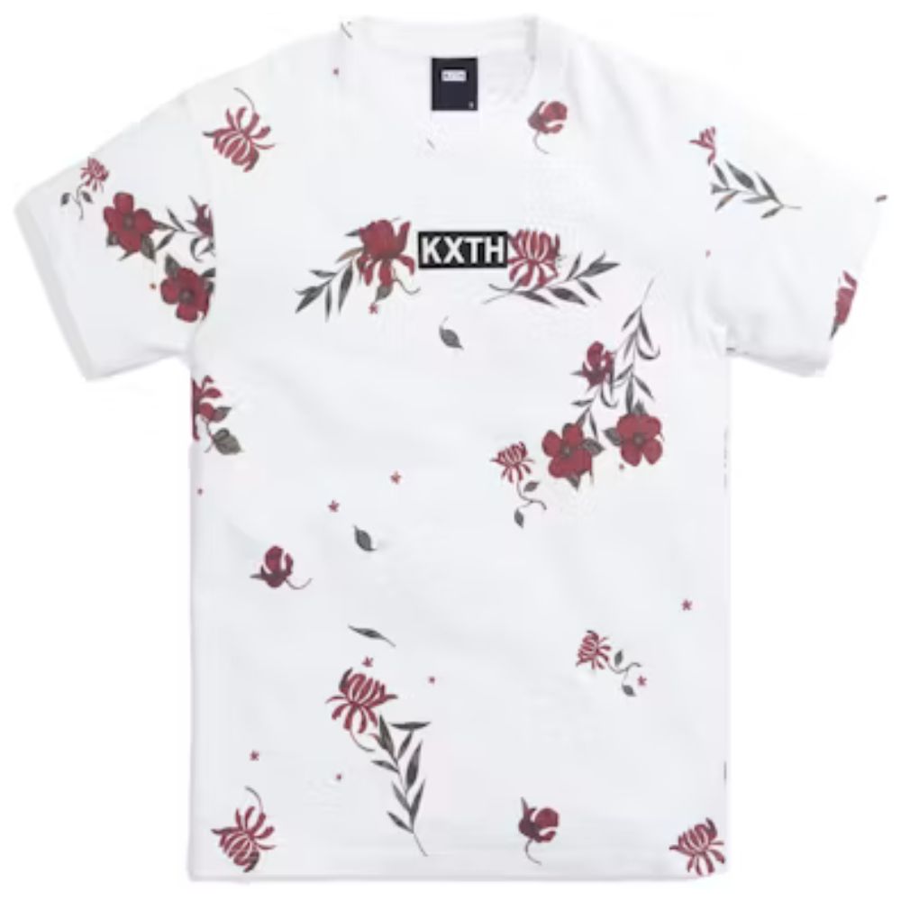 A white short-sleeve crewneck t-shirt by KXTH, featuring a scattered red and green floral print and a black rectangular logo patch on the chest with the brand name 'KXTH' in white.
