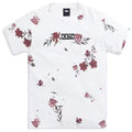 A white short-sleeve crewneck t-shirt by KXTH, featuring a scattered red and green floral print and a black rectangular logo patch on the chest with the brand name 'KXTH' in white.
