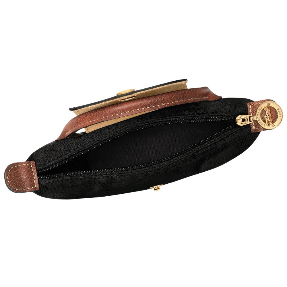 A black nylon pouch with brown leather trim and gold-tone hardware, shown open against a white background.