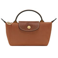 A brown leather handbag with a top handle, featuring a textured leather flap closure with a gold-tone circular logo medallion and a gold-tone zipper pull, shown against a plain white background.