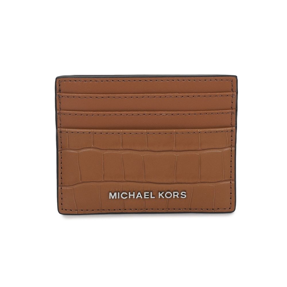 Michael Kors brown leather card holder with an embossed crocodile pattern and silver-tone logo lettering on a white background.
