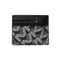 Michael Kors card holder wallet in black and gray monogram canvas with a black leather trim and a black brand tag, shown on a plain white background.