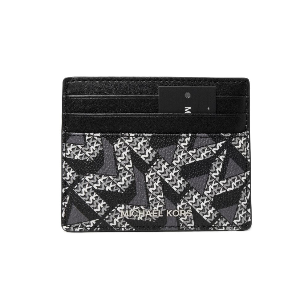 Michael Kors card holder wallet in black and gray monogram canvas with a black leather trim and a black brand tag, shown on a plain white background.