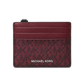 Michael Kors card holder in burgundy leather with a monogram pattern and silver-tone logo lettering, shown on a plain white background.