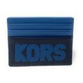 A blue and black leather cardholder wallet with the brand name 'KORS' embossed in blue on the front, set against a plain white background.