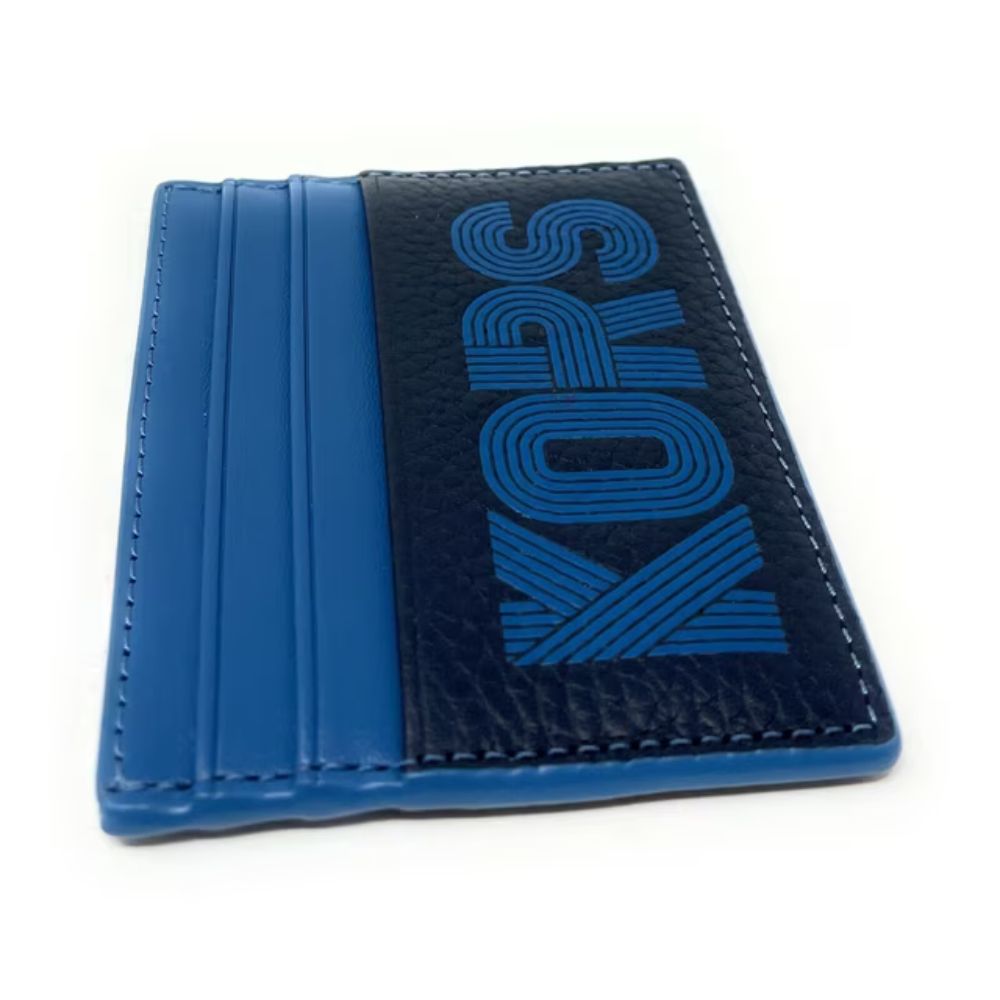A blue and black Kors slim card holder wallet with a textured leather panel featuring the brand name 'KORS' in blue, shown on a white background.