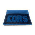 A blue and black leather cardholder wallet with 'KORS' embossed in blue on the front, shown on a plain white background.