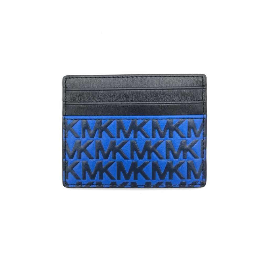 A Michael Kors slim card holder wallet featuring a black leather top section and a blue and black monogram patterned lower section, shown on a plain white background.