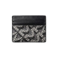 A black leather card holder wallet featuring a black and white geometric monogram pattern on the lower half, shown against a plain white background.