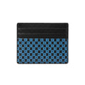 A black leather card holder wallet featuring a blue and black checkered pattern on the lower half with the brand name 'KORS' printed in white on each square.