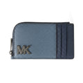 A Michael Kors zip-around wallet in textured blue leather with a dark navy cardholder slot on the right side and a metallic silver 'MK' logo on the front.