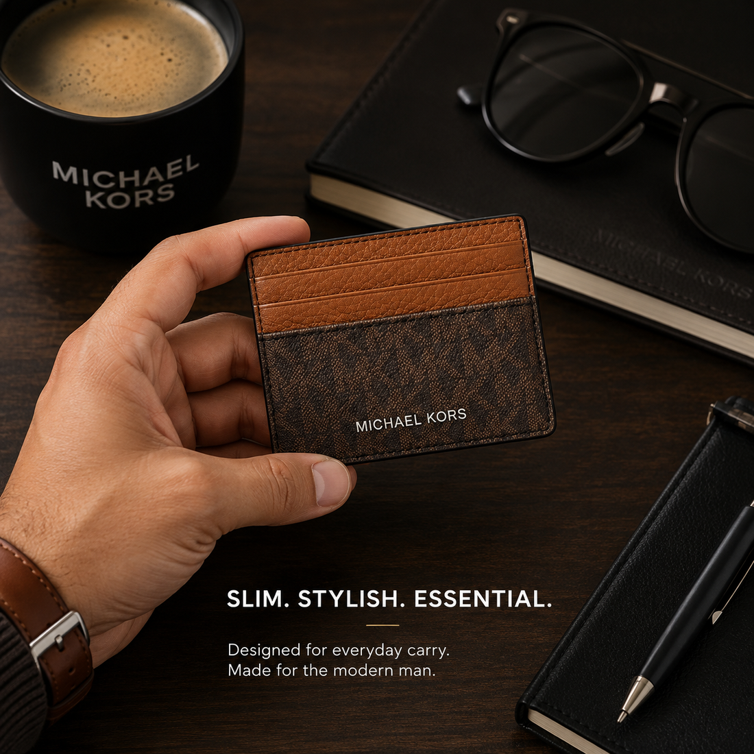Michael Kors card holder in brown monogram canvas with a lighter brown leather stripe across the top, featuring the MICHAEL KORS logo in white on the front, set against a plain white background.