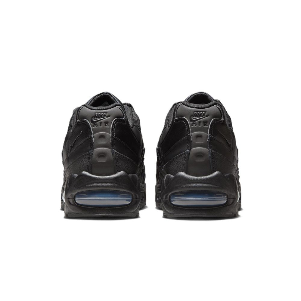 A pair of black Nike Air Max 90 sneakers shown from the back, featuring black mesh and synthetic overlays with a translucent blue Air unit in the heel.