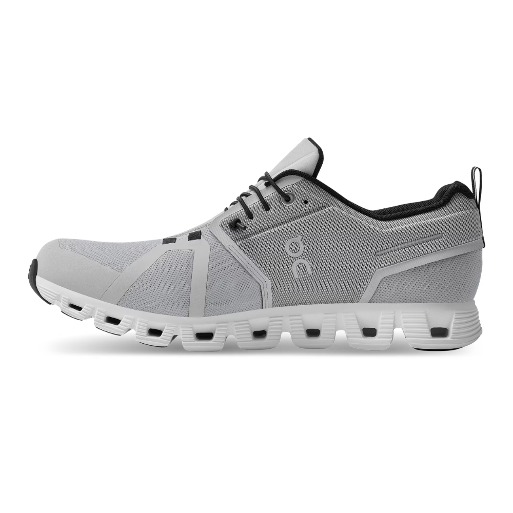 Black athletic shoe with white sole on a white background