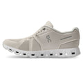 Beige running shoe with 'On' logo on a white background