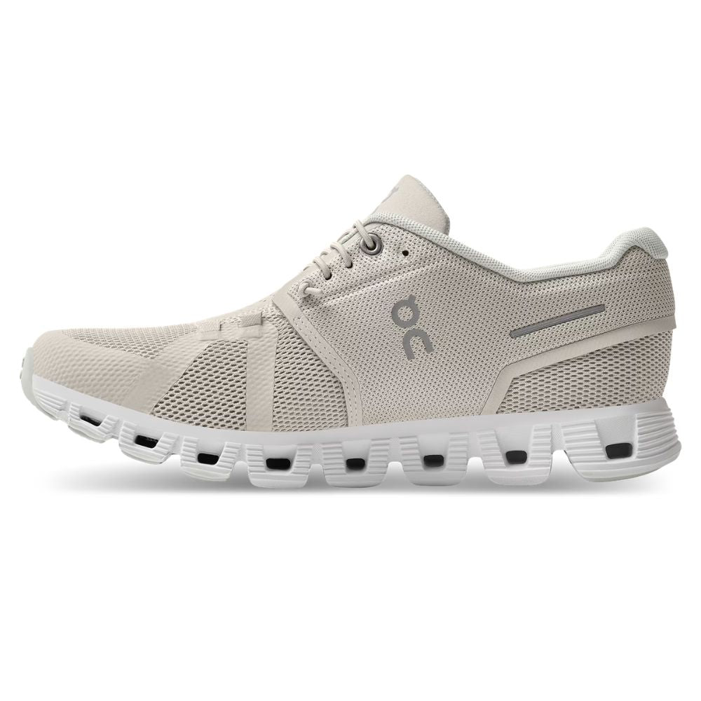 Beige running shoe with 'On' logo on a white background