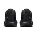 A pair of black athletic sneakers shown from the rear, featuring a chunky black sole and a pull tab with the 'on' logo, set against a plain white background.